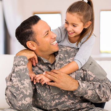 Soldier looking happily at daughter